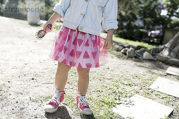 Little girl wearing fashionable skirt  partial view