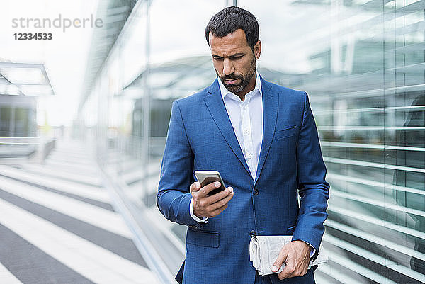 Portrait of businessman using smartphone