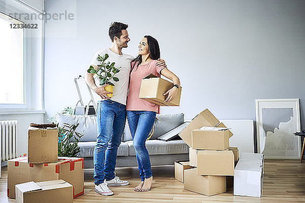 Happy couple unpacking in new apartment