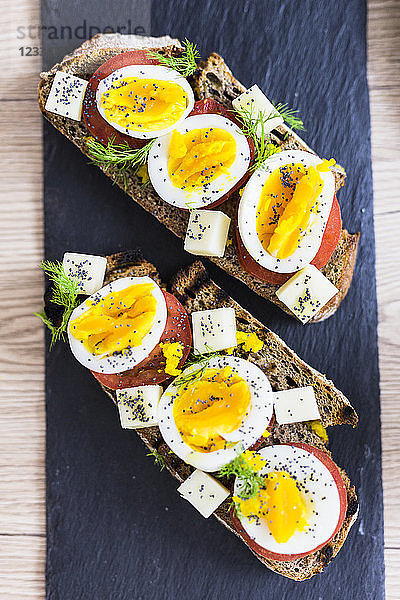 Vegetarian breakfast with bread  eggs and tomato slices on slate