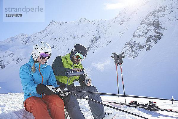 Austria  Tyrol  Kuehtai  two skiers in winter landscape having a break