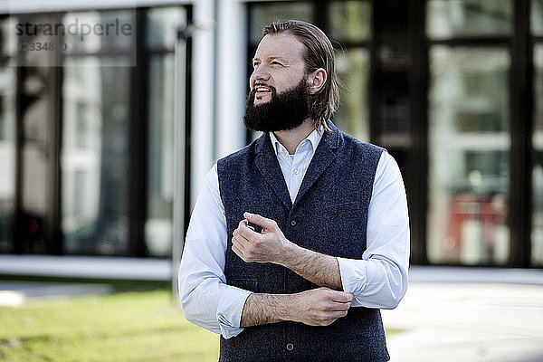 Portrait of bearded businessman watching something