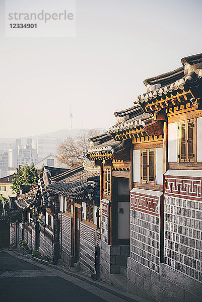 South Korea  Bukchon Hanok Village  street with traditional houses  Seoul Tower in the background