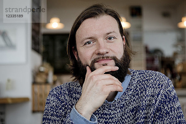 Man with beard sitting in cafe  portrait