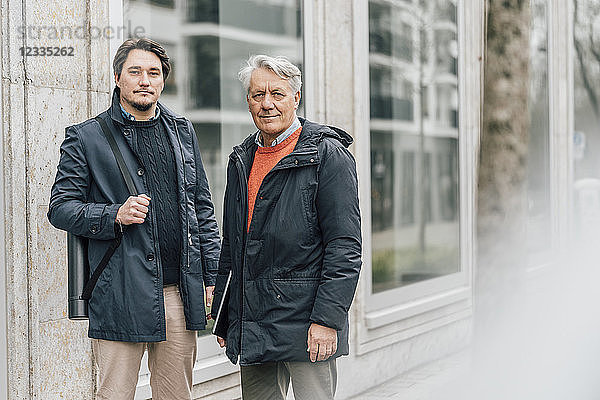 Portrait of young man and senior man in the city