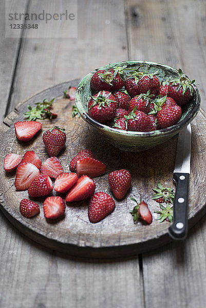 Whole and sliced organic strawberries