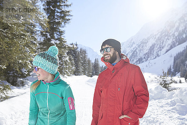 Happy couple in snow-covered landscape