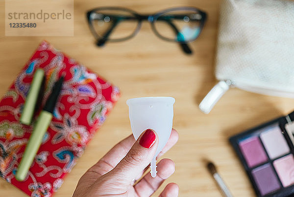 Woman holding a menstrual cup