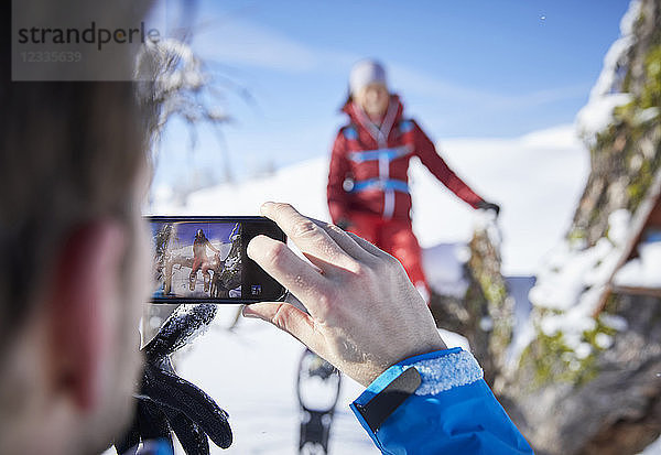 Austria  Tyrol  hiker taking a photo with smartphone