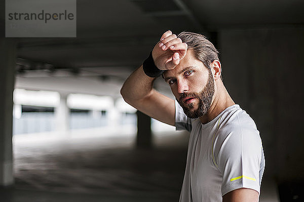 Portrait of athlete in parking garage with sweatband