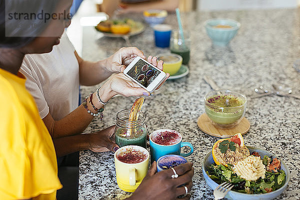 Woman showing smartphone picture in a cooking workshop