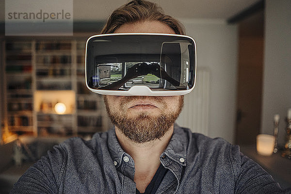 Mature man taking selfie of himself  wearing VR glasses  looking cool