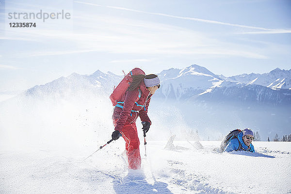 Austria  Tyrol  snowshoe hikers running through snow  man falling