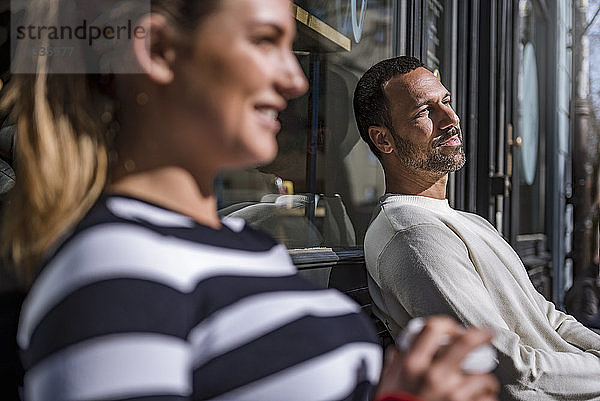 Man and woman relaxing outside a cafe