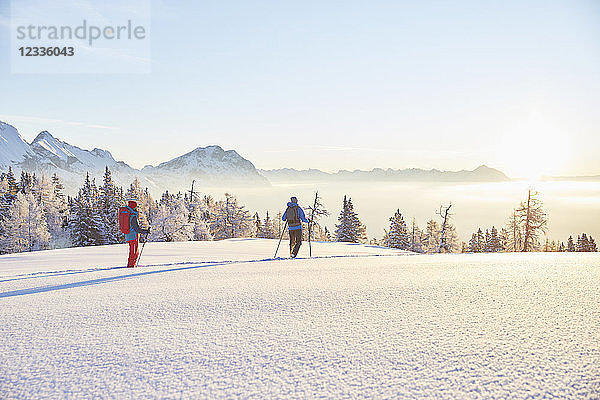 Austria  Tyrol  snowshoe hikers at sunrise
