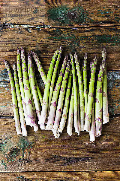 Green asparagus on wood
