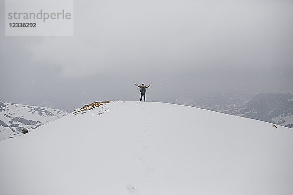 Austria  Kitzbuehel  back view of happy man enjoying snow-covered landscape