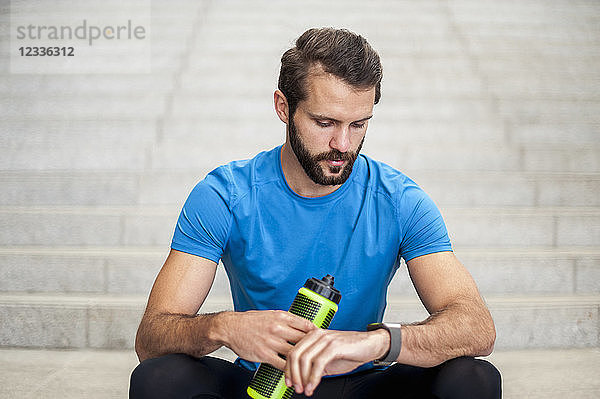 Man sitting on stairs having a break from running