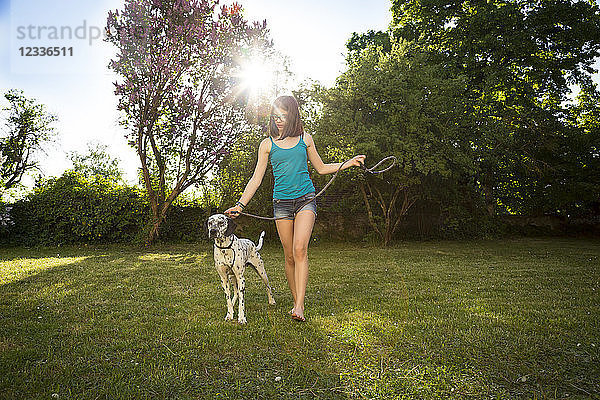 Girl with Dalmatian in the garden
