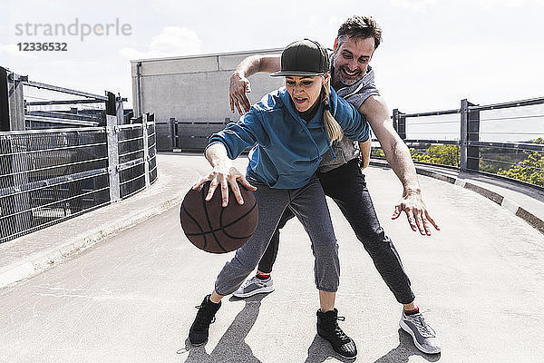 Man and woman playing basketball