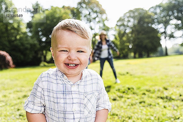 Portrait of happy boy with motherin a park