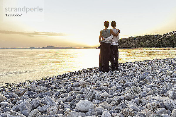 Greece  Pelion  couple enjoying at sunset at beach