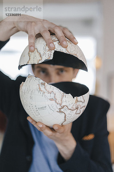 Man holding broken globe