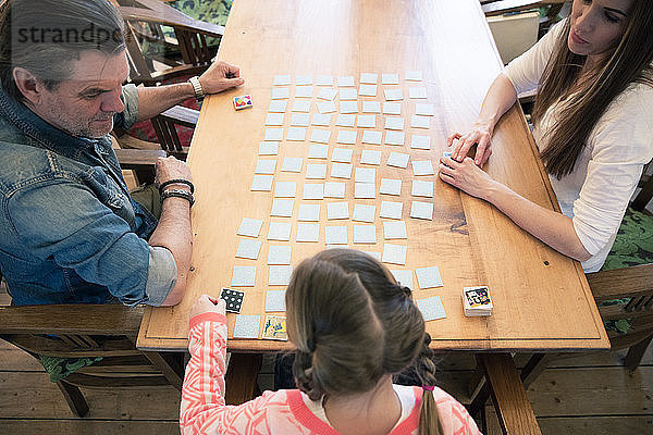 Family playing memory on table at home