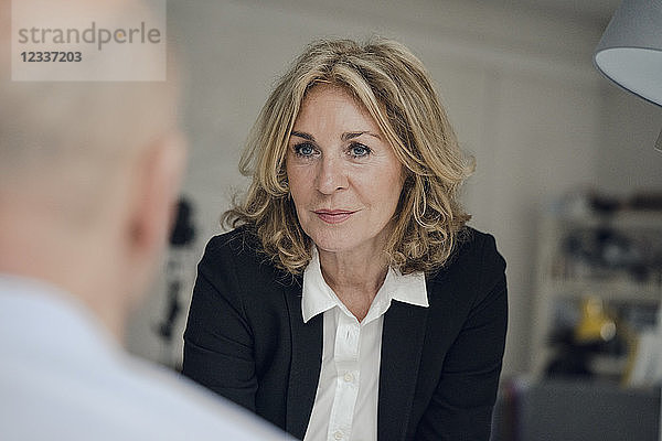Senior businesswoman looking at colleague