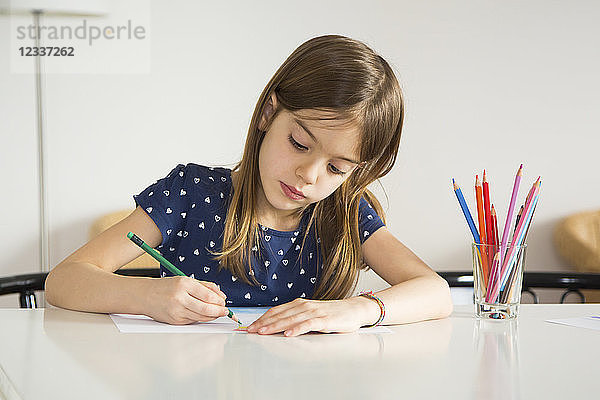 Portrait of little girl drawing