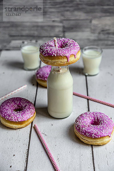 Pink doughnuts and bottle of milk