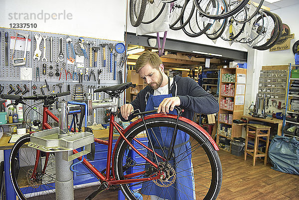Bicycle mechanic working in his repair shop
