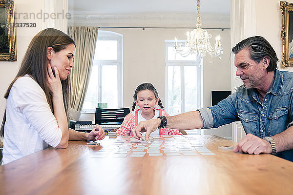 Family playing memory on table at home