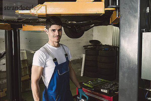 Portrait of smiling mechanic in his workshop