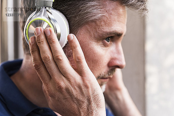Man listening music with headphones  close-up
