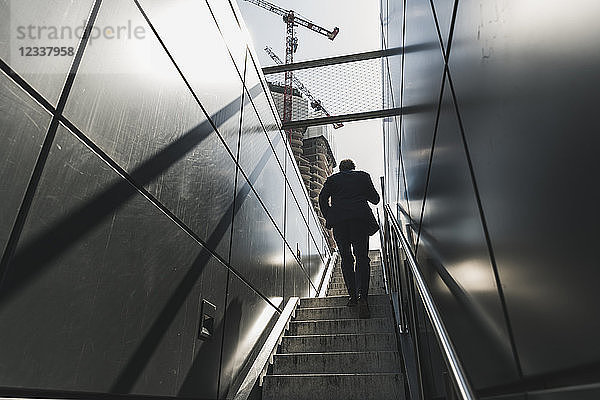 Businessman walking on staircase in the city