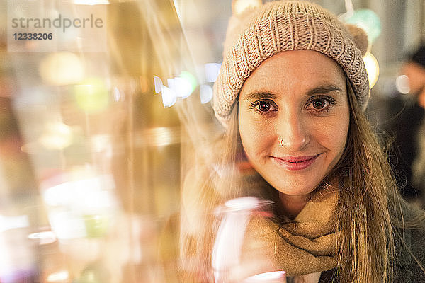 Portrait of smiling young woman at Christmas market