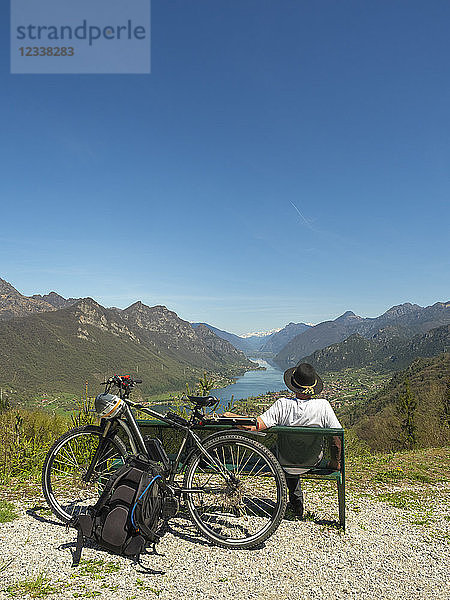 Italy  Lombardy  Senior hiker looking over Idro lake  Adamello Alps  Parco Naturale Adamello Brenta