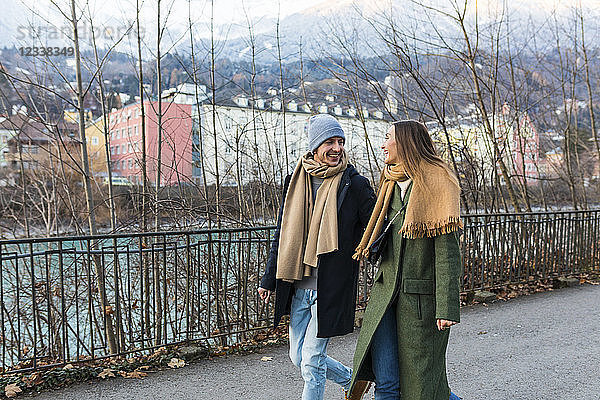 Austria  Innsbruck  happy young couple strolling together at winter time