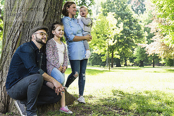 Happy family under a tree in a park