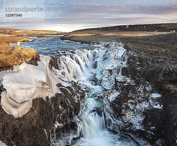 Wasserfall mit Eis und Schnee im Winter  Kolugljúfur  Sonnenuntergang  Norðurland vestra  Nordisland  Island  Europa