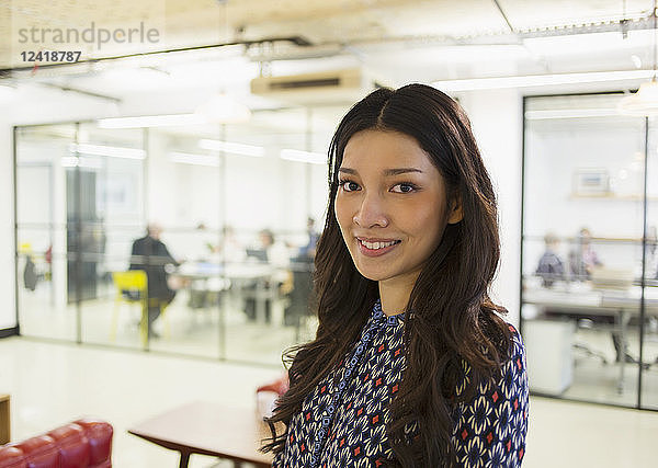 Portrait confident young businesswoman in office