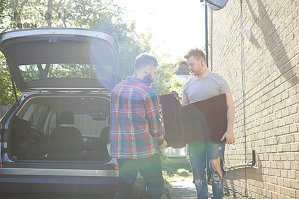 Male gay couple moving furniture