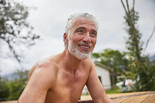 Portrait smiling  confident mature man in hot tub sunny summer deck