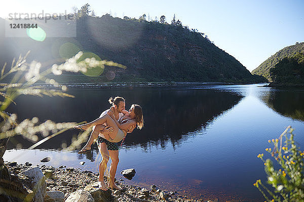 Romantic  carefree couple at sunny summer lake