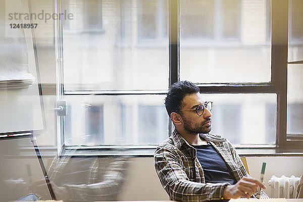 Attentive businessman listening in conference room meeting