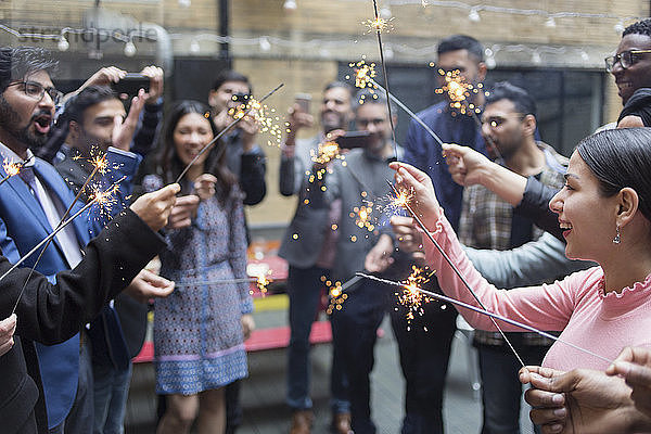 Friends celebrating with sparklers at party