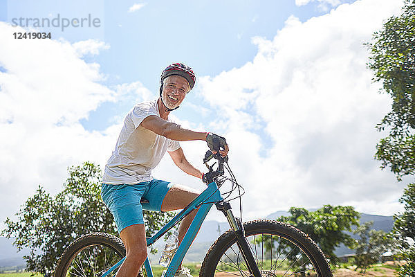 Portrait smiling  confident mature man mountain biking