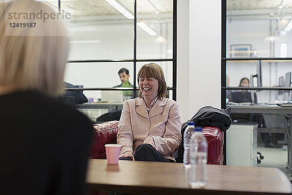 Laughing businesswoman in meeting