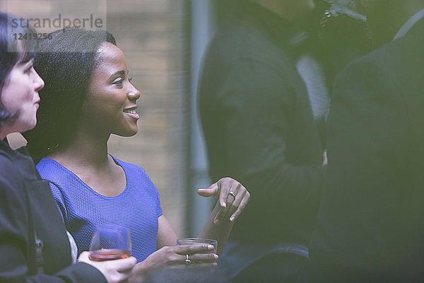 Smiling woman socializing at party